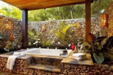 03 a jacuzzi covered with stone and with a stone wall all around to keep the space private