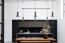 04 The dining space features a stained wooden table and benches with black framing