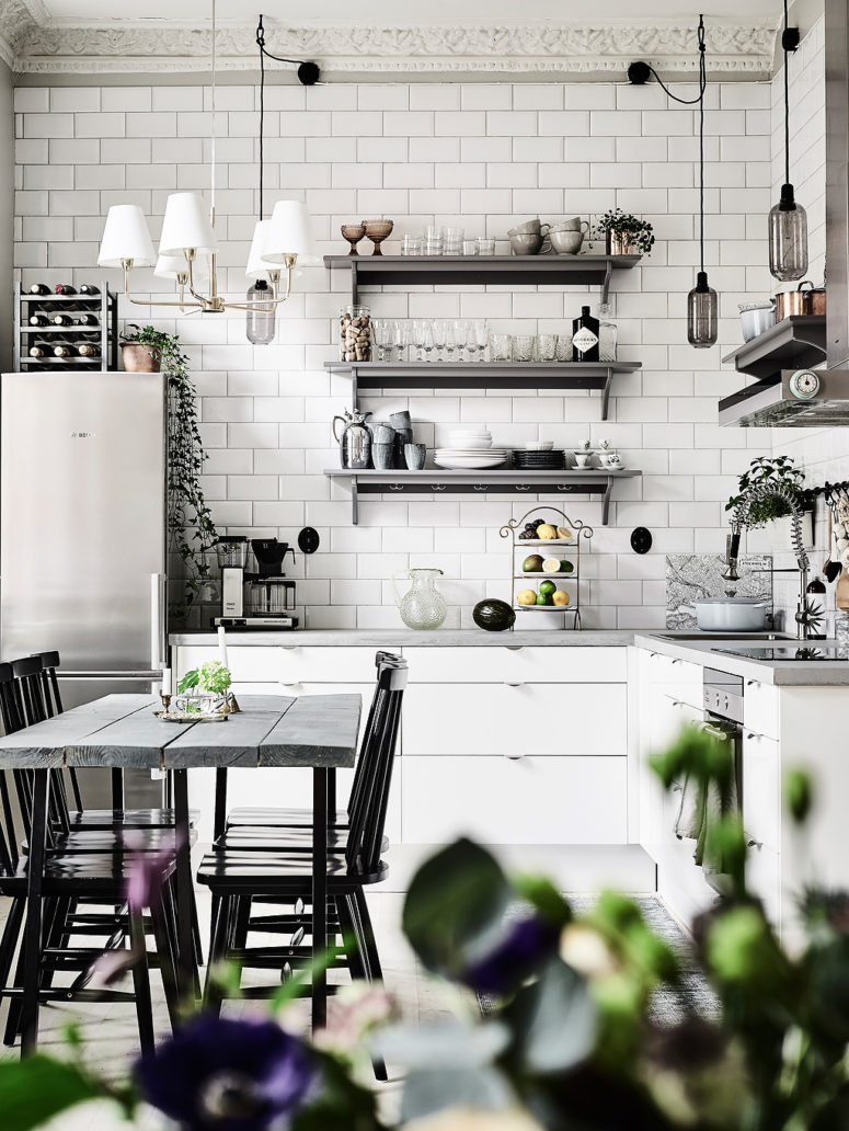 subway style kitchen backsplash The kitchen is clad with simple white tiles, there are white cabinets and open metal shelves