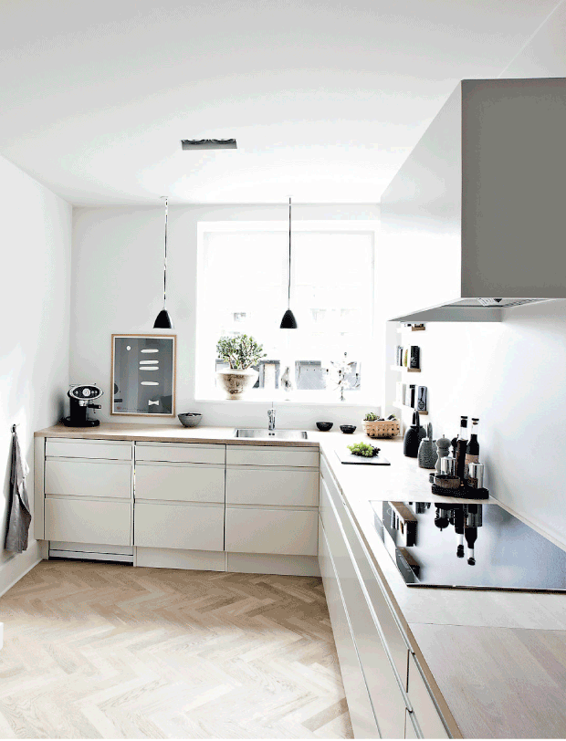 The kitchen isn't big but very comfy with white cabinets and wooden countertops, black accents make it more eye-catching