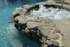 04 a hot tub covered with riverstone to separate it from a kidney-shaped pool