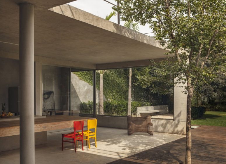 outdoor dining area Here you'll see an outdoor dining space with a thick dining table and colorful chairs and floor-to-ceiling windows
