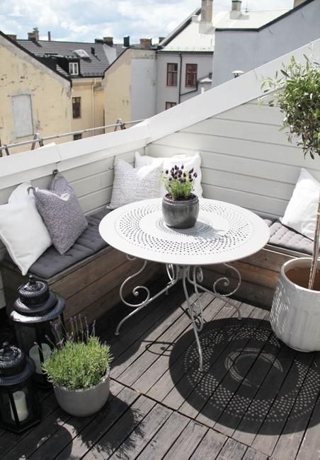 a small rooftop Scandinavian terrace with a pallet storage bench, which is a perfect fit