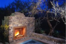 05 sunken jacuzzi clad with stone and with a fireplace in front of it for more comfort
