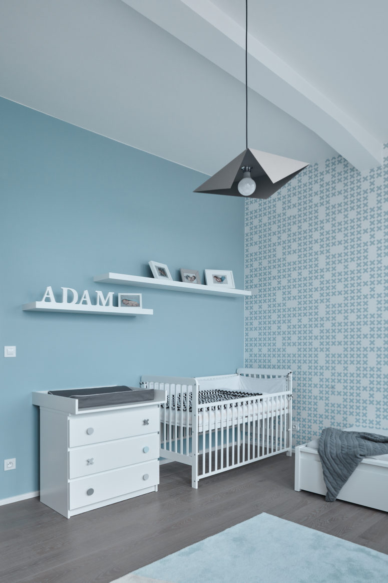 minimalist boy's nursery design A pastel shade of blue was used for the nursery room, impregnating a soothing and serene ambiance