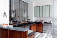 06 The kitchen is eclectic with warm-colored cabinets and stainless steel appliances