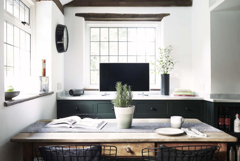 greenery for decor There are various cool touches like potted greenery and modern graphite vases that give a personality to the space