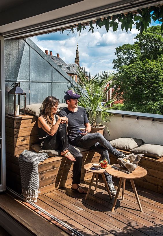 small terrace with a pallet wooden bench with lots of storage inside it