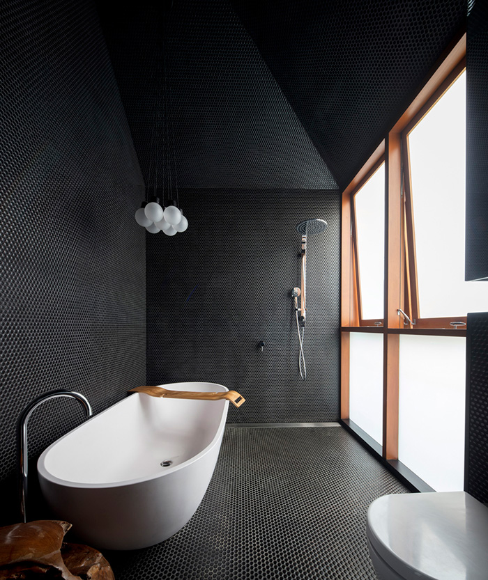 black bathroom design The bathroom is covered with black penny tiles and light-colored wood gives it a more exquisite look