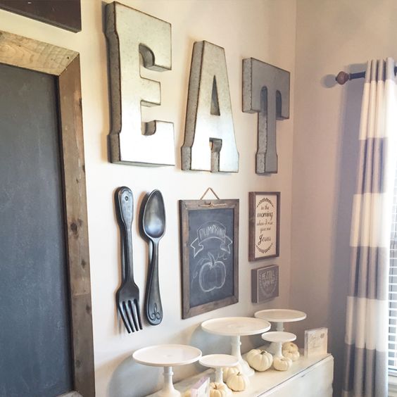 a large EAT sign, several chalkboard ones and oversized utensils