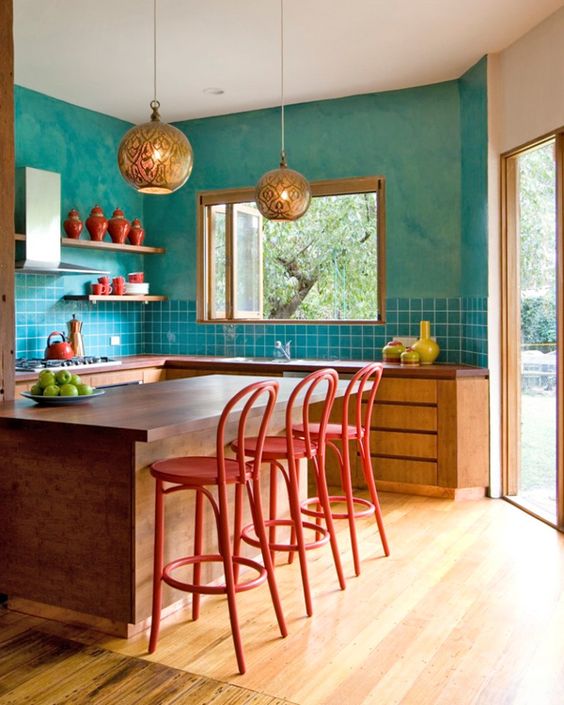 turquoise walls, tiles and red chairs for a Morocco-inspired interior