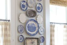 10 blue and white plates and silver trays for decorating a dining space