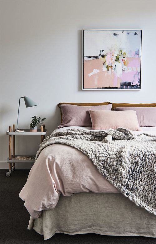 blush bedding and a cool blush picture add a soft feel to the space