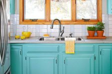 11 colorful blue cabinets and bold floral curtains make the kitchen spring-like
