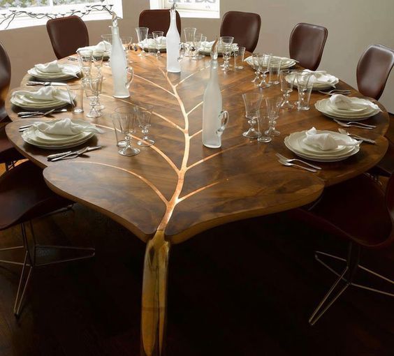 refined wooden leaf dining table with gold details looks just wow