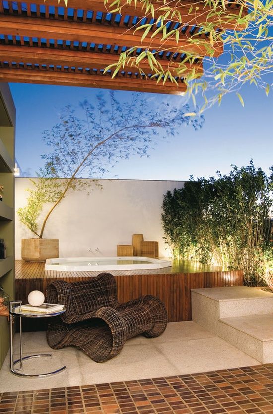 a jacuzzi sunken into a wood clad platform for a ool natural feel