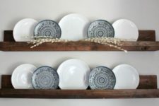 16 dark stained wooden shelves with plates for wall decor