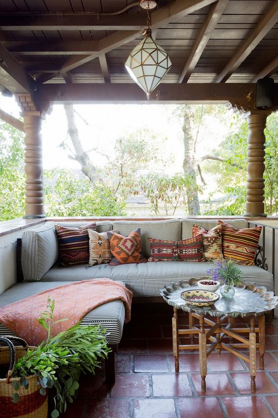a terrace with a soft upholstered bench with pillows for cozy spending time together