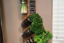18 a wooden plank with herbs growing and chalkboard tags