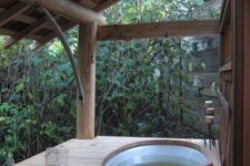 19 outdoor jacuzzi with a wooden deck and a roof over it gives a natural feel to the space