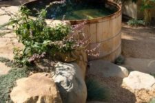 20 a cedar clad jacuzzi with stone and greenery around for a natural feel
