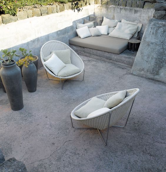 rounded white wicker chairs with creamy cushions