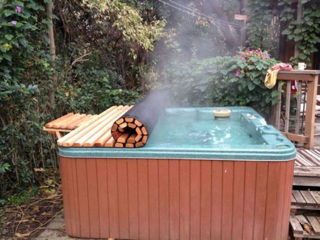 a hot jacuzzi can be covered with a rolling cover to keep it hot