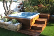 25 a jacuzzi with wooden steps and a wooden planter with succulents around