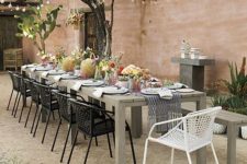 26 metal frame chairs with wicker contrast with a wooden table