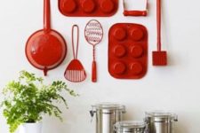 26 red reclaimed utensils on a kitchen wall will catch an eye and look super cute