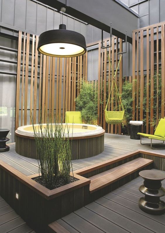 a stylish wooden deck with steps and a jacuzzi, a living green wall