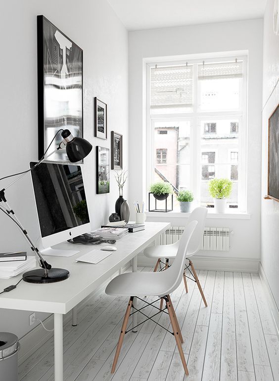 a modern and whitewashed office is made inviting with some modern pots