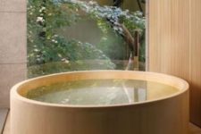 30 Japanese-style jacuzzi covered with light-colored wood on a matching deck