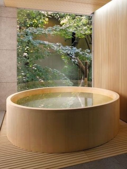 Japanese-style jacuzzi covered with light-colored wood on a matching deck