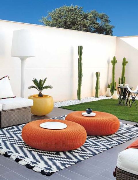 flat round wicker ottomans in bold orange