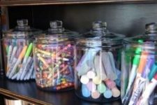 32 glass jars with various office supplies look cool