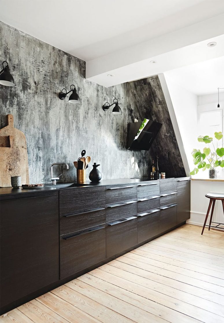 kitchen wallpaper The kitchen features a graphic wallpaper wall as a backsplash, there are black cabinets and wall lamps