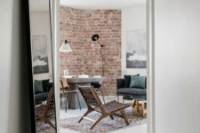 02 The living room features a brick wall and a concrete table, the furniture is comfy and very eye-catchy, look at this leather woven chair