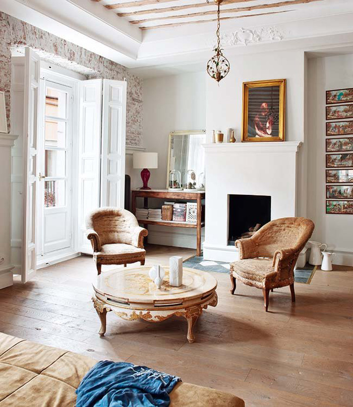 living room with brick walls The living room features original brick walls and wooden beams on the ceiling and walls, I love an antique vintage candle lantern