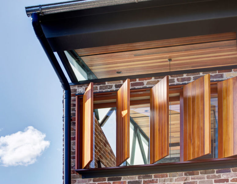 To soften the rough brick look, the designers used much warm-colored wood in the decor