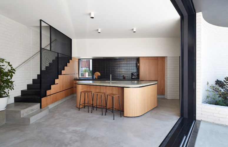 The inner decor is somewhat a blend of modern and mid century modern aesthetics, in white, black and natural wood The inner decor is somewhat a blend of modern and mid-century modern aesthetics, in white, black and natural wood
