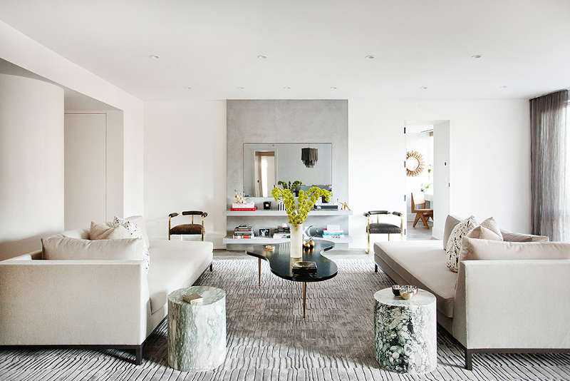 The living room is done in neutral shades liek creamy and grey, the furniture seems simple but the materials are refined