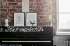 03 The piano in the living room is styled to minimalism with its black and painted white decor