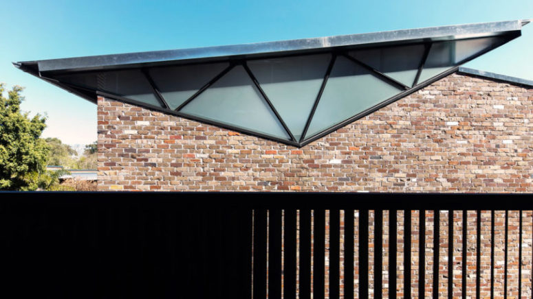 The trusses used at the rear of the house were inverted to form the low, sloped roofline