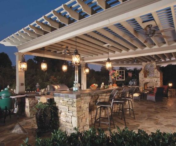 cozy lanterns hanging from the pergola above the kitchen
