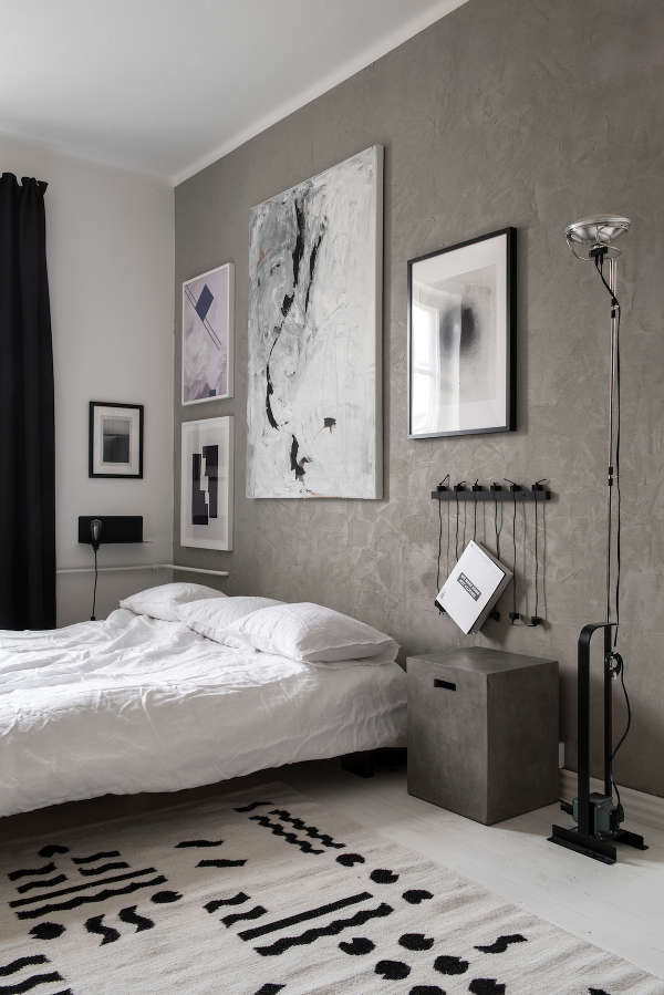 bedside tables The bedroom has a grey accent wall and matching bedside tables, all the rest is laconic black and white
