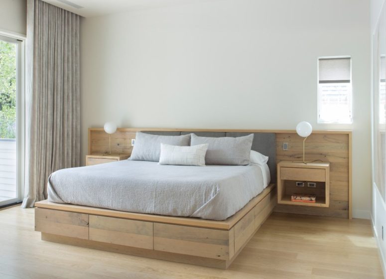 floating nightstand The master bedroom is modern and almost minimalist, with light-colored wooden platform bed and floating nightstands