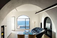 06 The living room is light-filled, with modern upholstered furniture and stunning sea views