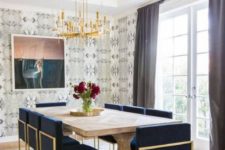 art deco navy and gold upholstered chairs create a cool glam ambience