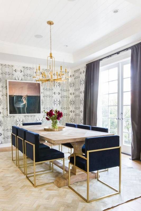 art deco navy and gold upholstered chairs create a cool glam ambience